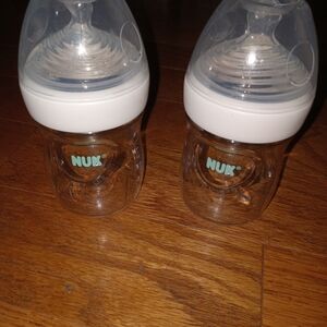 2 5oz Nuk baby bottles with lids